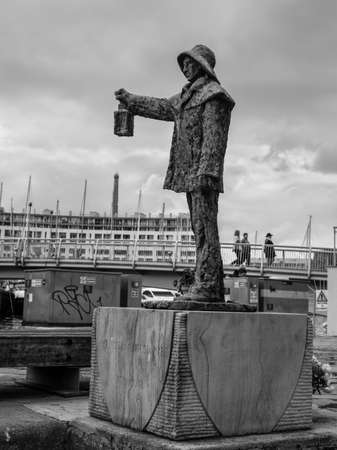 Savona, Italy - December 2, 2016: Fisherman statue at Harbour quayside of Savona in Liguria, Italy. Black and white photography.のeditorial素材