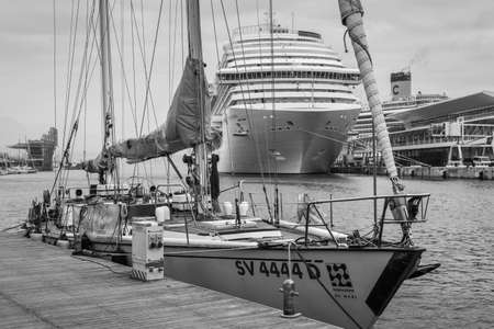 Savona, Italy - December 2, 2016: Yacht and cruise ship moored in harbor at the Ligurian sea port in...