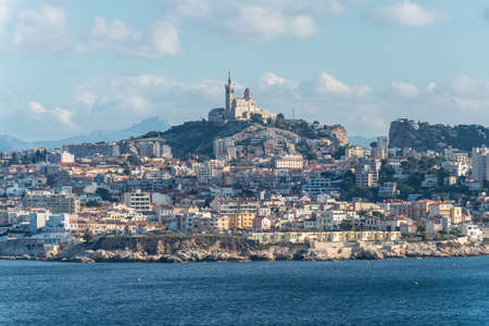 Seaside view of the city of Marseille and the historic church Notre Dame de la Garde from Frioul archipelago in South Franceの写真素材