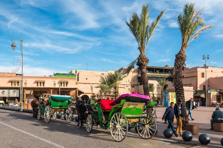 Marrakesh, Morocco - December 8, 2016: Horse-drawn carriages waiting for tourists in Marrakesh,...