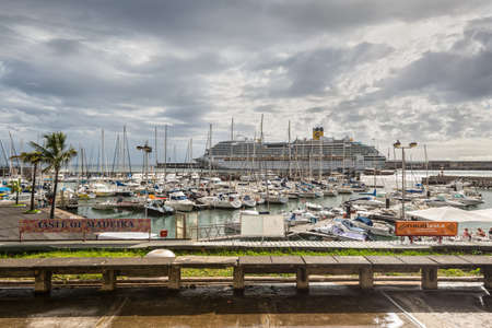 Funchal, Portugal - December 10, 2016: Street view from the promenade to the yachts and cruise ship in the port of Funchal, Madeira Island, Portugal after the rain.のeditorial素材
