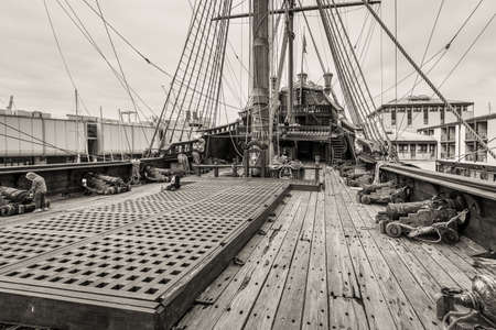 Genoa, Italy - May 14, 2017: The upper deck of the sailing wooden ship Galleon Neptun in Porto antico in Genoa, Italy. Black and white photography sepia toned. Sea adventure background.のeditorial素材