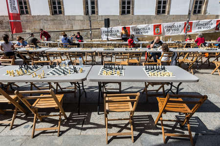 Vigo, Spain - May 20, 2017: People playing chess in the street of Vigo, Galicia, Spain. Chess Boards in the Street Ready for a Game in the foreground.のeditorial素材