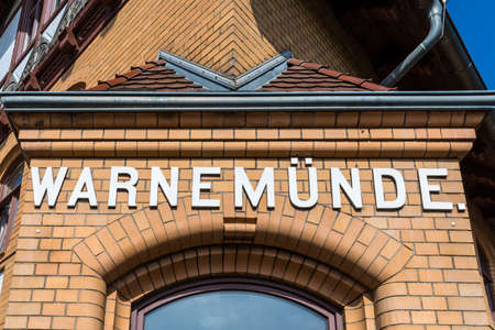 Rostock, Germany - May 26, 2017: Station name on the building of the Warnemunde Railway Station in Warnemunde, Rostock, Mecklenburg, Germany.のeditorial素材