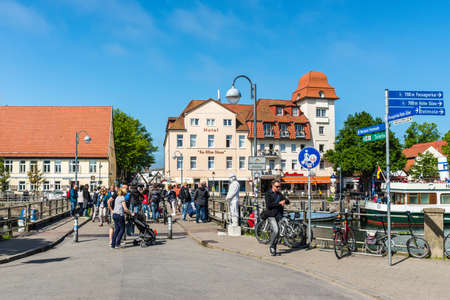 Rostock, Germany - May 26, 2017: Crowds of tourists walking along the bridge over the canal on this spring hot day in Warnemunde, Rostock, Mecklenburg, Germany.のeditorial素材