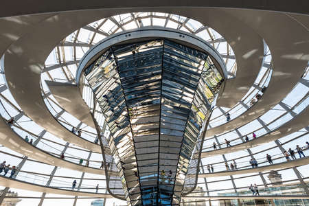 Berlin, Germany - May 27, 2017: People visit the Deutscher Bundestag in Berlin, Germany. It is a glass dome constructed on top of rebuilt Reichstag to symbolize the reunification of Germany. Reichstag building, seat of the German Parliament.のeditorial素材