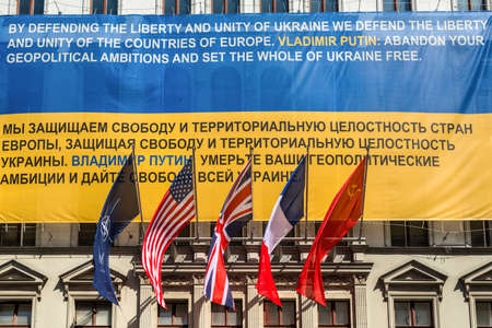 Berlin, Germany - May 28, 2017: Flags of Ukraine, NATO, USA, UK, France, former USSR on the wall of the Haus am Checkpoint Charlie museum as solidarity with Ukraine in Berlin, Germany.のeditorial素材