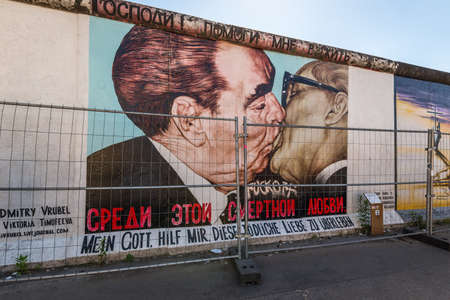 Berlin, Germany - May 27, 2017: Part of the East Side Gallery graffiti of the author Dimitry Vrubel representing the kiss between Brezhnev and Honecker on the Berlin Wall.のeditorial素材