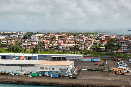 Fort-de-France, Martinique - December 19, 2016: A residential neighborhood and warehouses in the foreground at port of Fort de France, the capital of Martinique, an overseas department of France.のeditorial素材