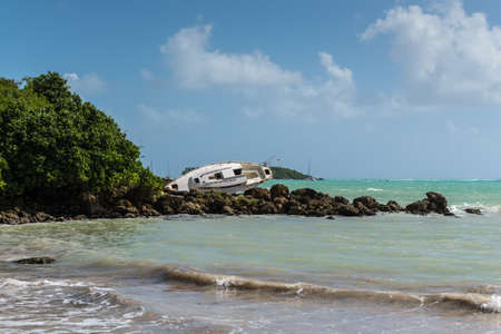 Sailboat was destroyed and abandoned on the shore after a hurricane - the Gosier in Guadeloupe,...