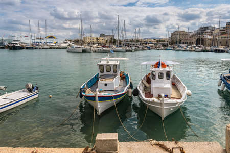 Heraklion, Crete, Greece - November 2, 2017: Old harbour of Heraklion with fishing boats and marina,...