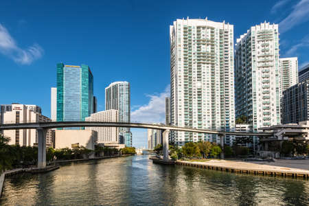 Miami, FL, USA - April 19, 2019: View of downtown financial and residential buildings and Brickell key on a spring day with blue sky and green waters of Miami river.のeditorial素材