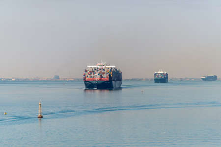 Suez, Egypt - November 5, 2017: Large container vessels (ships) passing Suez Canal in the sandy haze (The Great Bitter Lake) near Suez, Egypt, Africa.のeditorial素材