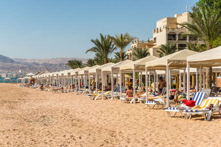 Aqaba, Jordan - November 6, 2017: People relaxing on the beach on the Red Sea in the Gulf of Aqaba at the InterContinental Aqaba Hotel in Aqaba, Jordan.のeditorial素材