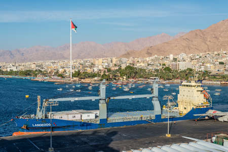 Aqaba, Jordan - November 6, 2017: Cityscape of Aqaba. General cargo vessel Langeoog moored in port of Aqaba, Jordan.のeditorial素材