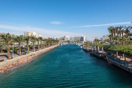 Eilat, Israel- November 7, 2017: View from Moshe Kol Memorial Bridge to marina, surrounded by promenades with palms, cafes, restaurants and shopping centers in Eilat, Israel.のeditorial素材