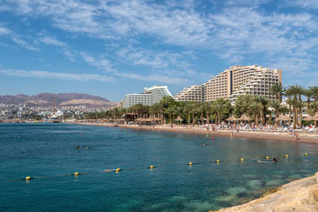 Eilat, Israel - November 7, 2017: People are enjoying a sunny day on a beach in Eilat, Israel. This serene location is a very popular tropical getaway for Israeli.のeditorial素材