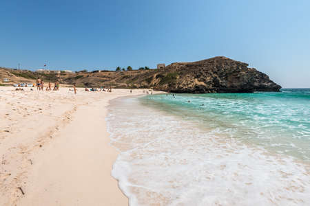 Salalah, Oman - November 12, 2017: People are resting and relaxing on the sunny Oasis Beach in Oman,...