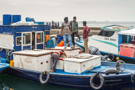 Male, Maldives - November 16, 2017: Area of fresh fish market in cloudy weather in Male, Maldives. Fishermen on a boat are preparing to deliver large tuna and seafood for sale.のeditorial素材