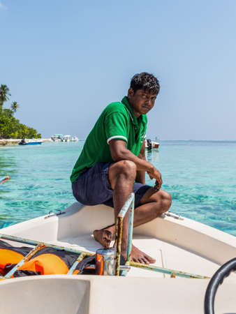 Huraa, Maldives - November 19, 2017: Guide on a boat en route to the Turtle and Shark Safari tour near the island of Huraa in the Maldives, North Male Atoll, Indian Ocean.のeditorial素材
