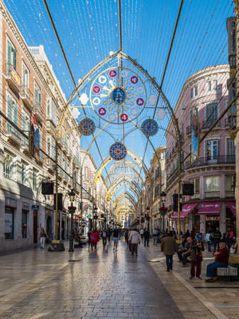 Malaga, Spain - December 4, 2018: People walk along pedestrian Larios Street decorated for Christmas in downtown of Malaga, Andalusia, Spain.のeditorial素材