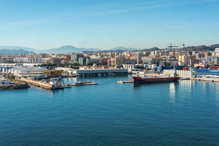 Malaga, Spain - December 4, 2018: Cityscape of Malaga with residential areas, urban infrastructure, a commercial port on the Mediterranean coast.のeditorial素材