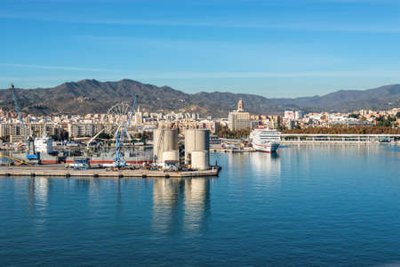 Malaga, Spain - December 4, 2018: Cityscape of Malaga with residential areas, urban infrastructure, a commercial port on the Mediterranean coast.のeditorial素材
