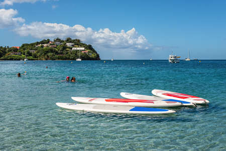 Les Trois-Ilets, Martinique - December 13, 2018: Surfboards (SUP boards) in the foreground of the...