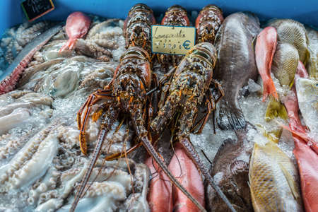 Spiny lobsters and fresh seafood are on ice at the fish market in Pointe-a-Pitre, Guadeloupe