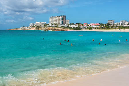 Mullet Bay, Saint Martin - December 17, 2018: Tourists and locals bathe on the Mullet Bay Beach which is not far from Maho beach near Princess Juliana Airport, Caribbean island of Saint Martin.のeditorial素材