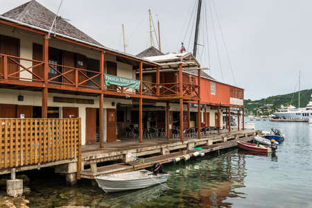 English Harbour, Antigua and Barbuda - December 18, 2018: Cafes, restaurants, offices and shops in the Antigua Yacht Club in cloudy weather, located in English Harbour, Antigua and Barbuda.のeditorial素材