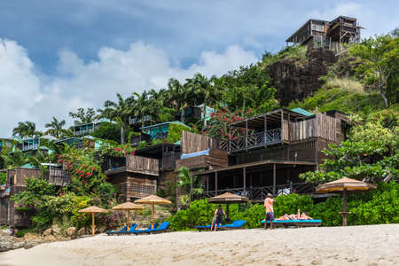Valley Church Bay, Antigua and Barbuda - December 18, 2018: Cocos Hotel with wooden cottages on a hill with view of the Caribbean in Antigua and Barbuda near Valley Church Beach.のeditorial素材