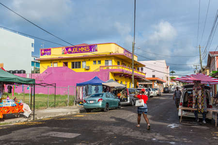 St John's, Antigua and Barbuda - December 18, 2018: Street view of St John's at rainy day with pedestrians and shops in St. John's, Antigua, West Indies, Caribbean.のeditorial素材
