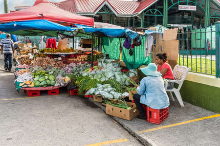 St John's, Antigua and Barbuda - December 18, 2018: Vendors fresh fruit and vegetable on a local market in St. John's, Antigua, West Indies, Caribbean.のeditorial素材