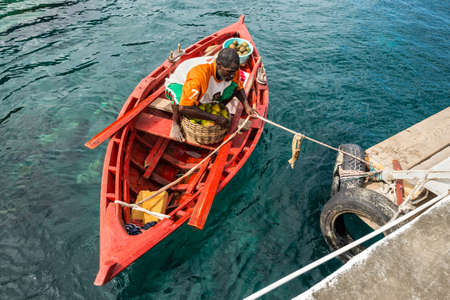 Wallilabou Bay, Saint Vincent and the Grenadines - December 19, 2018: Fruit merchant in a wooden boat brought fruit to the Wallilabou Anchorage - Pirates of the Caribbean's Port Royale - Saint Vincent.のeditorial素材