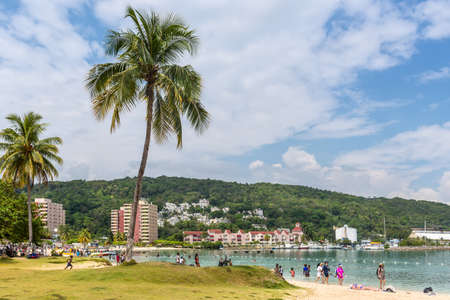 Ocho Rios, Jamaica - April 22, 2019: People relax on the Ocho Rios Bay Beach also referred to as Turtle Beach is nestled between Sunset Jamaica Grande on the eastern side and Ocho Rios Cruise Ship pier.のeditorial素材
