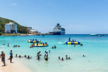 Ocho Rios, Jamaica - April 22, 2019: Local people relax on the Fisherman's Beach near Ocho Rios Cruise Ship pier. Today the city is one of Jamaica's most top tourist destinations.のeditorial素材