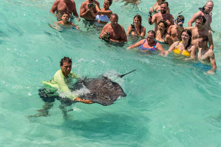 George Town, Grand Cayman Islands, United Kingdom - April 23, 2019: People enjoy playing with the...