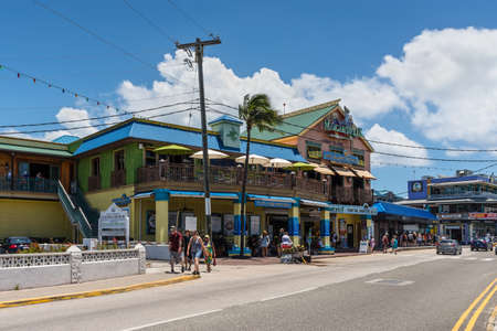 George Town, Grand Cayman Island, UK - April 23, 2019: Street view of George Town at day with pedestrians near tourist shops in downtown of George Town, Grand Cayman, Cayman Islands, British West Indies.のeditorial素材