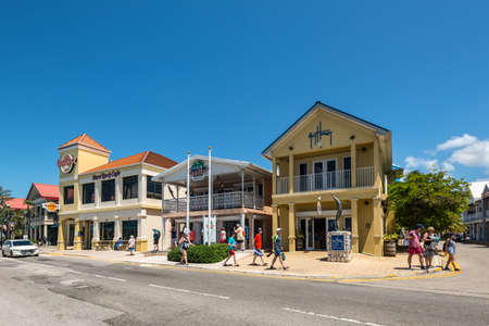 George Town, Grand Cayman Island, UK - April 23, 2019: Street view of George Town at day with pedestrians near restaurants and tourist shops in downtown of George Town, Grand Cayman, Cayman Islands.のeditorial素材