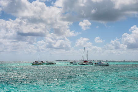 George Town, Grand Cayman Islands, United Kingdom - April 23, 2019: People enjoy playing with the stingrays at the sandbar of Stingray city on Gran Cayman in Cayman islands.のeditorial素材