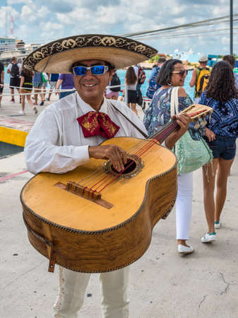 Cozumel, Mexico - April 24, 2019: Local musician play traditional music on mexican musical instrument to greet the passengers of a cruise ship in port of Cozumel, Mexico.のeditorial素材