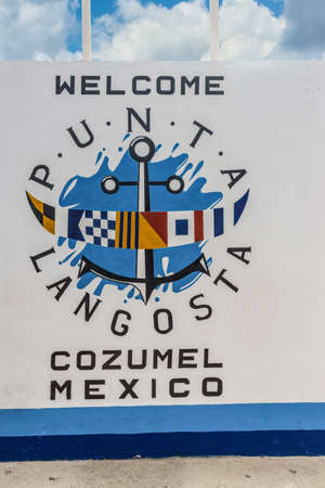 Cozumel, Mexico - April 24, 2019: Welcome to cozumel text banner invitation with marine coat of arms painted on textured white wall outdoor in Cozumel, Mexico, Caribbean.のeditorial素材