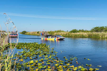 Everglades, United States of America - April 27, 2019: Group of tourists riding an airboat. The Everglades are a natural region of wetlands in the southern portion of the U.S. state of Florida.のeditorial素材