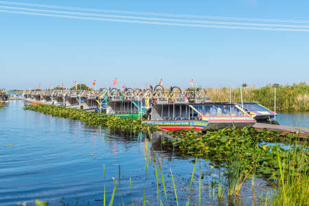 Everglades, United States of America - April 27, 2019: Tourist airboats moored in slender rows awaiting tourists in Everglades National Park, Florida.のeditorial素材