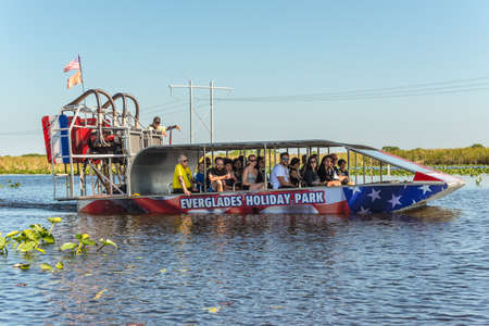 Everglades, United States of America - April 27, 2019: Group of tourists riding an airboat. They're fun but noisy! The Everglades are a natural region of wetlands in Florida, USA.のeditorial素材