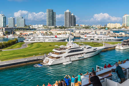 Miami, FL, United States - April 28, 2019: Passengers on the deck of a Cruise ship enjoying the view of Miami, Florida, United States and luxury yachts in the Biscayne Bay.のeditorial素材