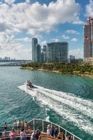 Miami, FL, United States - April 28, 2019: Passengers on the deck of a Cruise ship enjoying the view of Miami, Florida, United States and luxury yacht in the Intracoastal Waterway.のeditorial素材