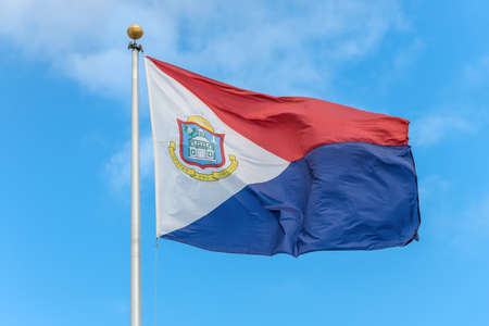 The national flag of Sint Maarten fluttering in the wind, a country within the Kingdom of the Netherlands occupying the southern half of the island of Saint Martin (Dutch part)の写真素材