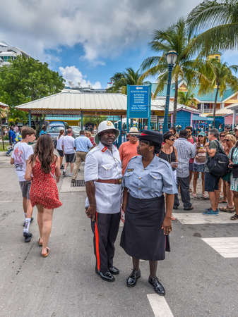 Nassau, Bahamas - May 3, 2019: Two Royal Bahamas Police officers (Man and woman) are keeping order in the streets. Nassau sees thousands of visitors daily, the majority of which arrive by cruise ship.のeditorial素材